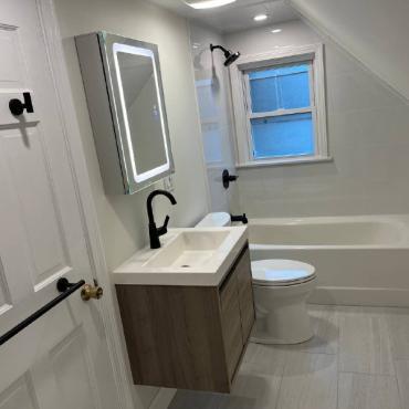 Modern Bathroom Transformation with Bathtub Shower and Custom Closet