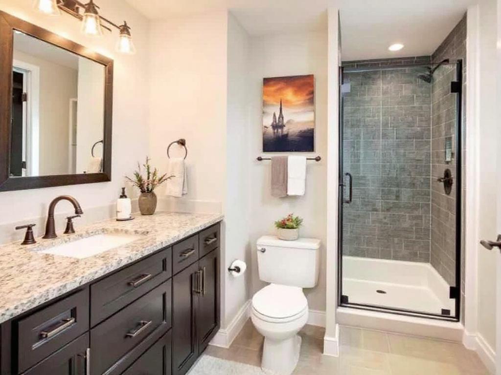 Elegant and functional bathroom remodel in a finished basement near Stoneham featuring a contemporary design.